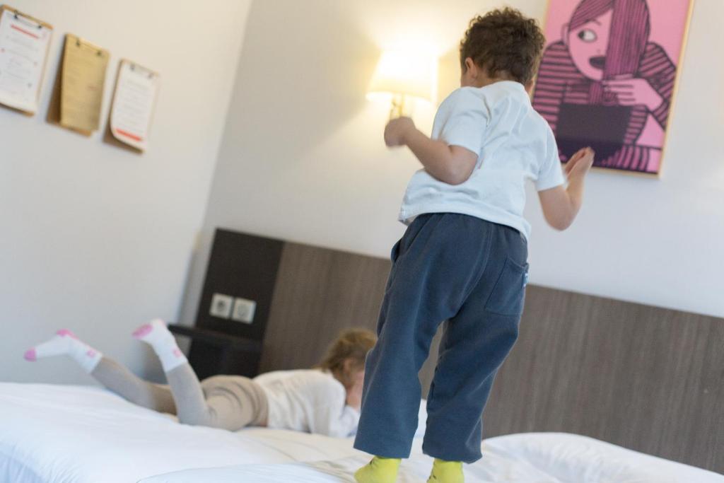 Postel nebo postele na pokoji v ubytování Hotel Gascogne