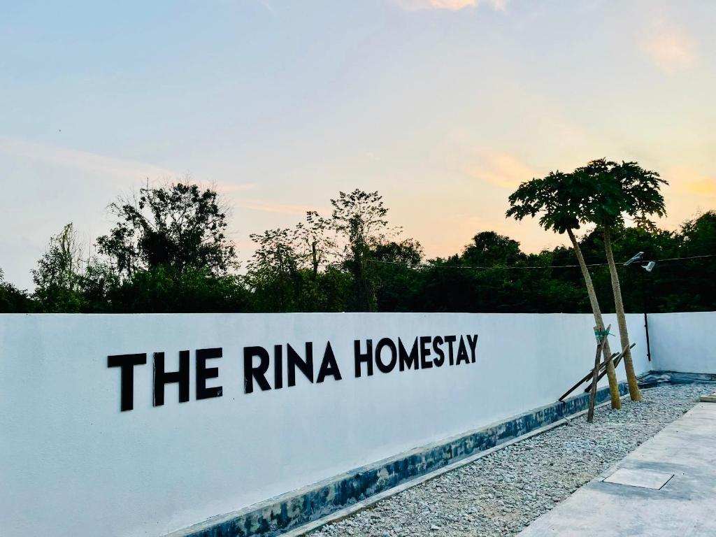 a white wall with the riniha homani written on it at The Rina Homestay-Whole Villa with Private Pool,BBQ & Karaoke-Near Beach- in Port Dickson