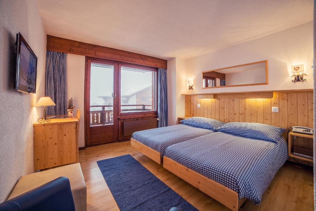 Postel nebo postele na pokoji v ubytování Hotel Mirabeau