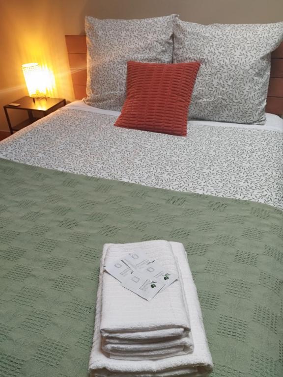 a bed with two towels on it with a poker at Albergue Kortarixar in Elizondo