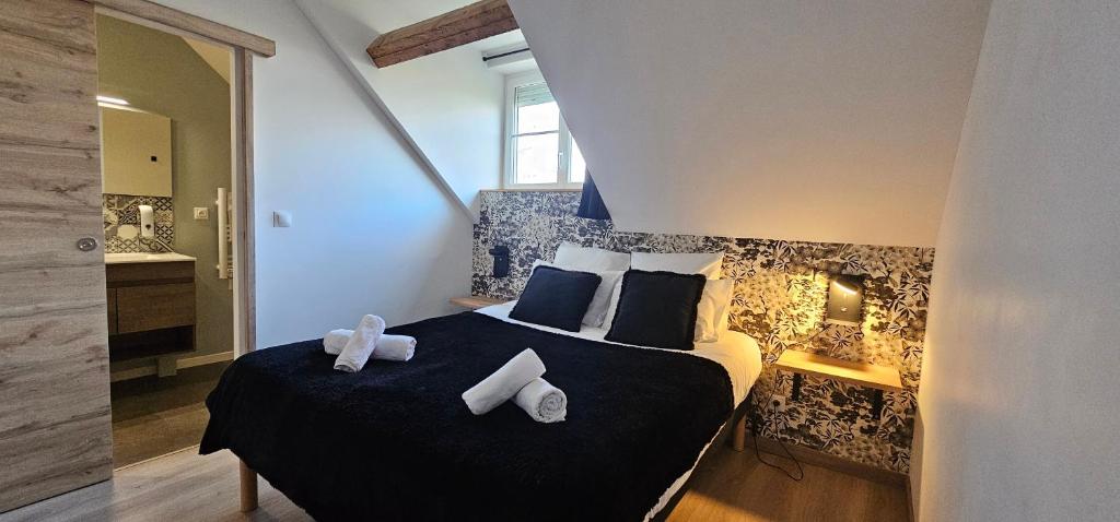 a bedroom with a bed with towels on it at Le Clos Maldier - Gîte de la Belle vue in Laon
