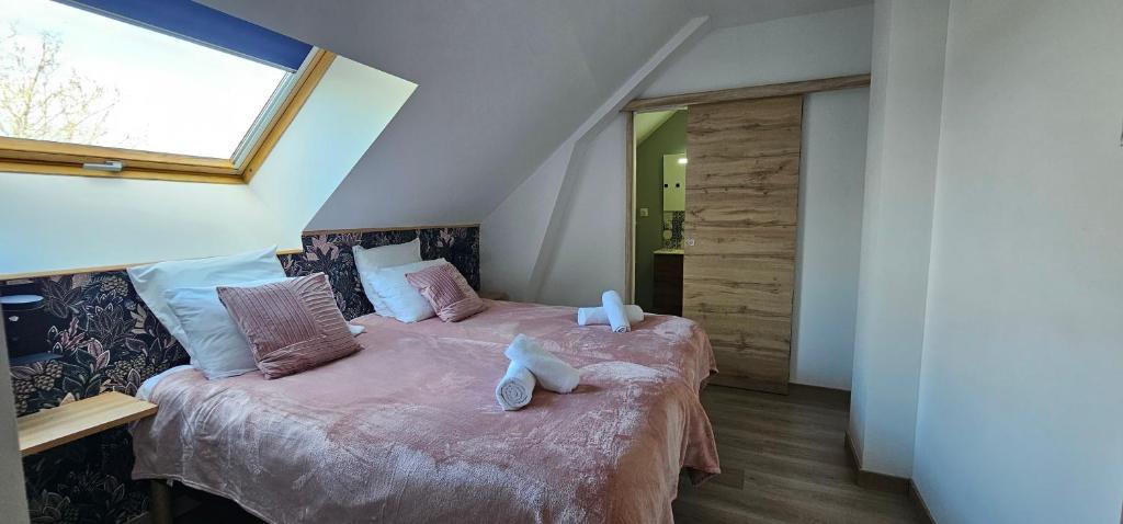 a bedroom with two beds and a window at Le Clos Maldier - Gîte de la Belle vue in Laon