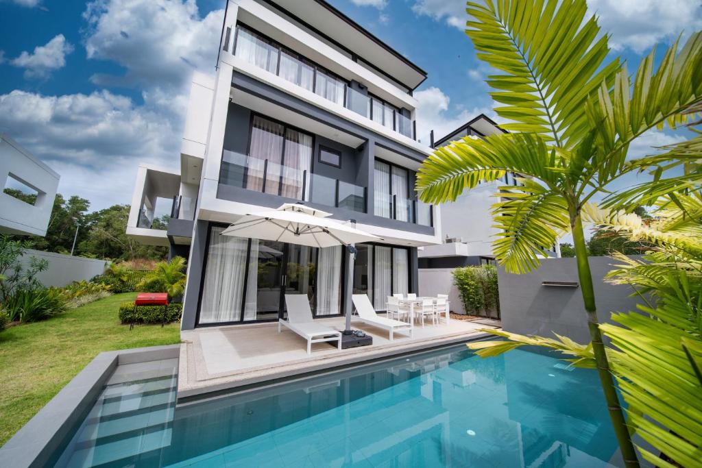 a house with a swimming pool and a villa at Private pool villa bangtao - laguna park in Ban Phru Champa