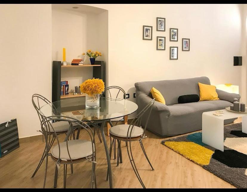 a living room with a glass table and a couch at Casa Anacleto in Iglesias