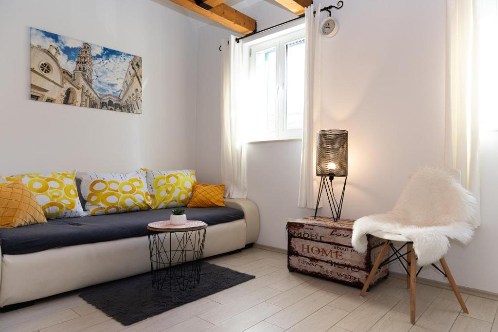 a living room with a couch and a chair at Central Split rooms and apartments Paese in Split