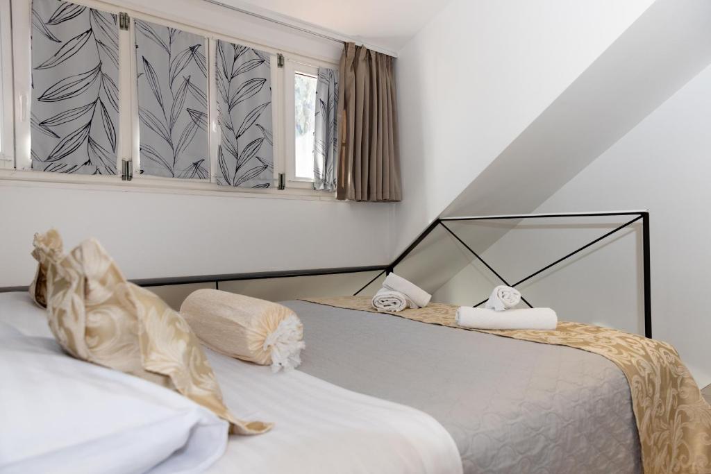 a bedroom with two beds and a window at Central Split rooms and apartments Paese in Split