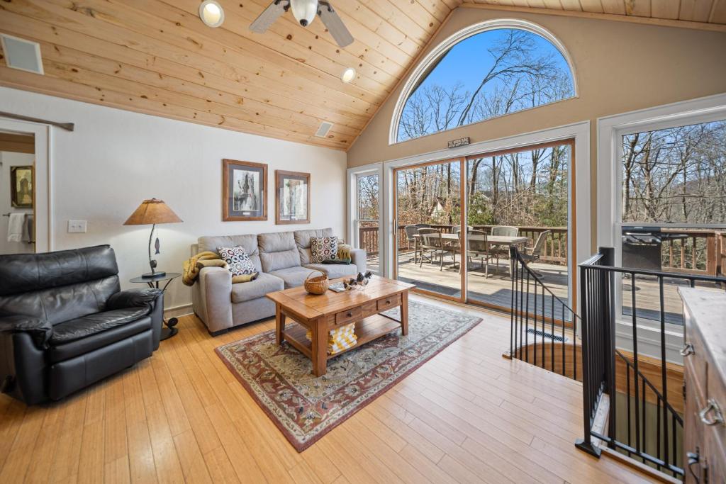 a living room with a couch and a table at Tree Top in Banner Elk