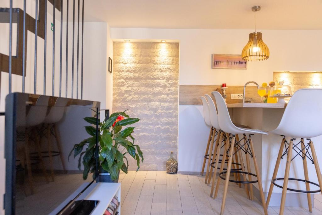 a kitchen with a counter and stools in a room at Central Split rooms and apartments Paese in Split