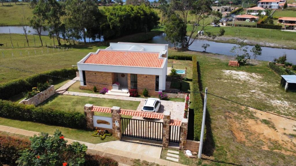 a small house with a red roof in a field at Villa Lucero 143 in Los Santos