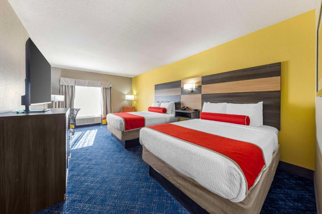 a hotel room with two beds and a flat screen tv at Best Western Plus Midwest City Inn & Suites in Midwest City