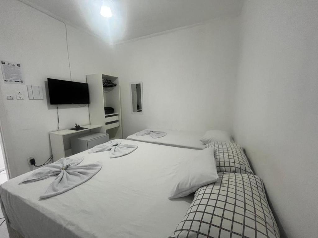 Postel nebo postele na pokoji v ubytování Hotel Aconchegante