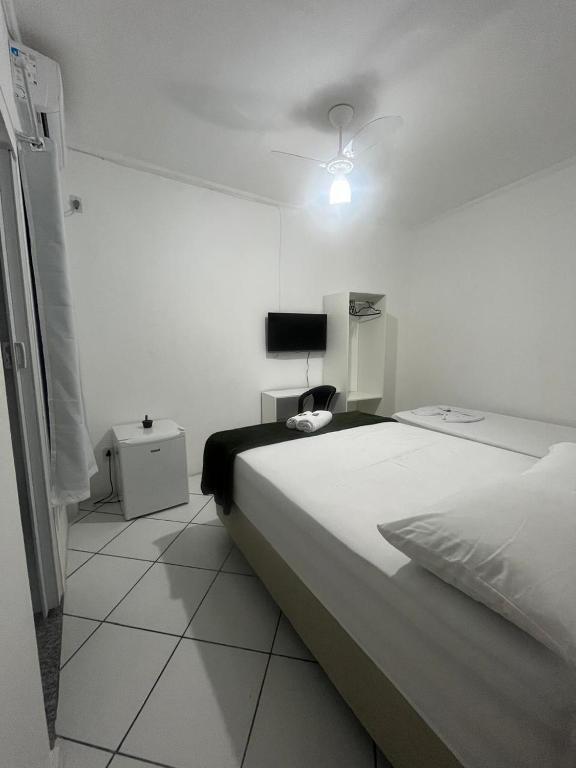 Postel nebo postele na pokoji v ubytování Hotel Aconchegante
