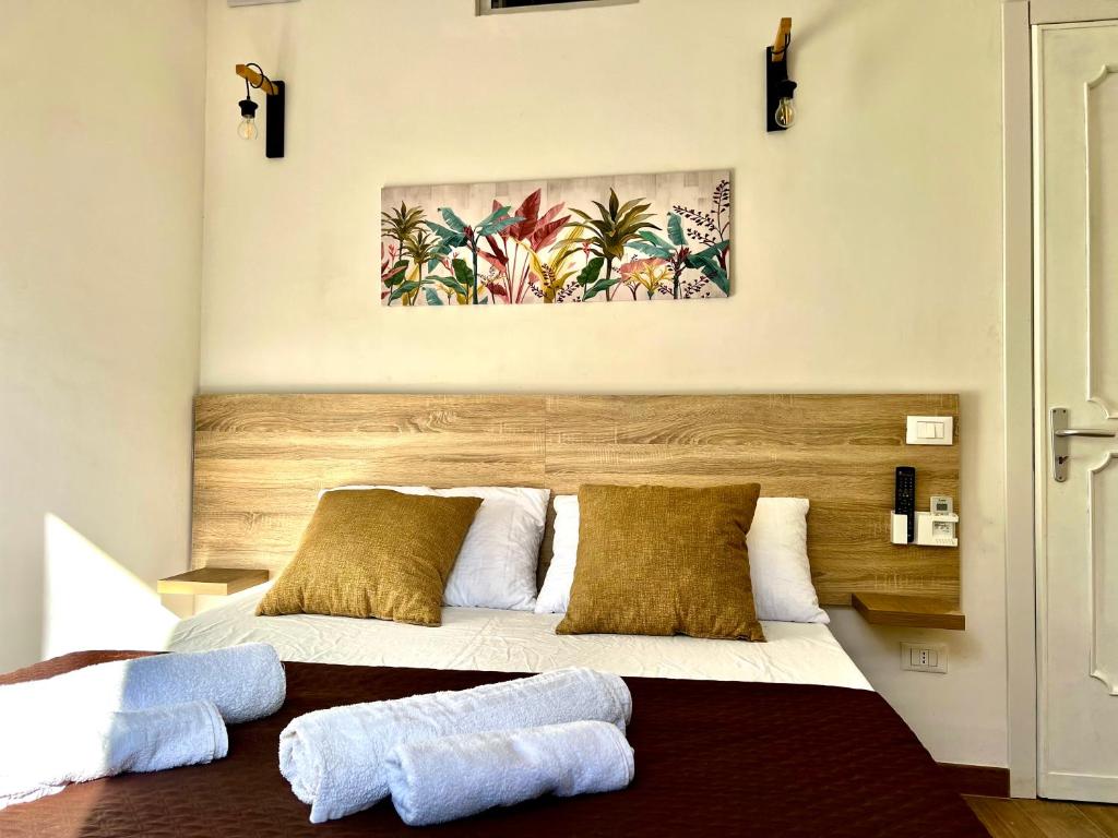 a bedroom with a bed with two towels on it at Egadi Home in Favignana