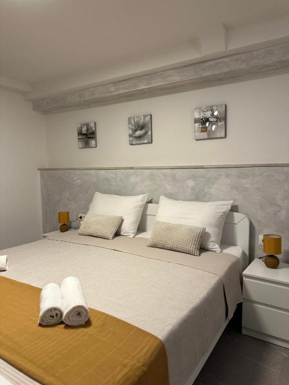 a bedroom with a large bed with two towels on it at Apartment Bilić in Pula