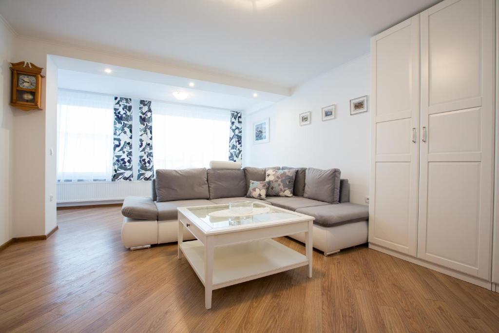 a living room with a couch and a table at Apartments Grom in Bled