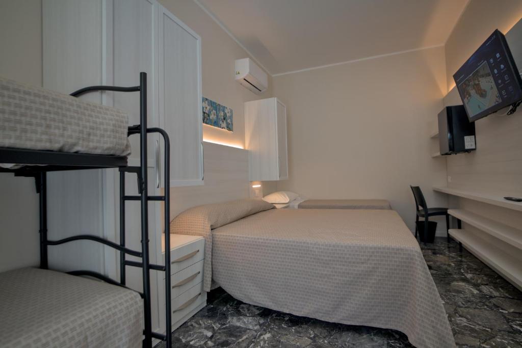 Postel nebo postele na pokoji v ubytování Hotel Cinzia