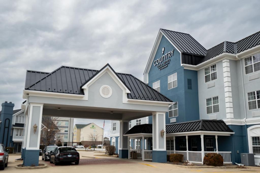 a large blue and white hotel with a parking lot at Country Inn & Suites by Radisson, Effingham, IL in Effingham