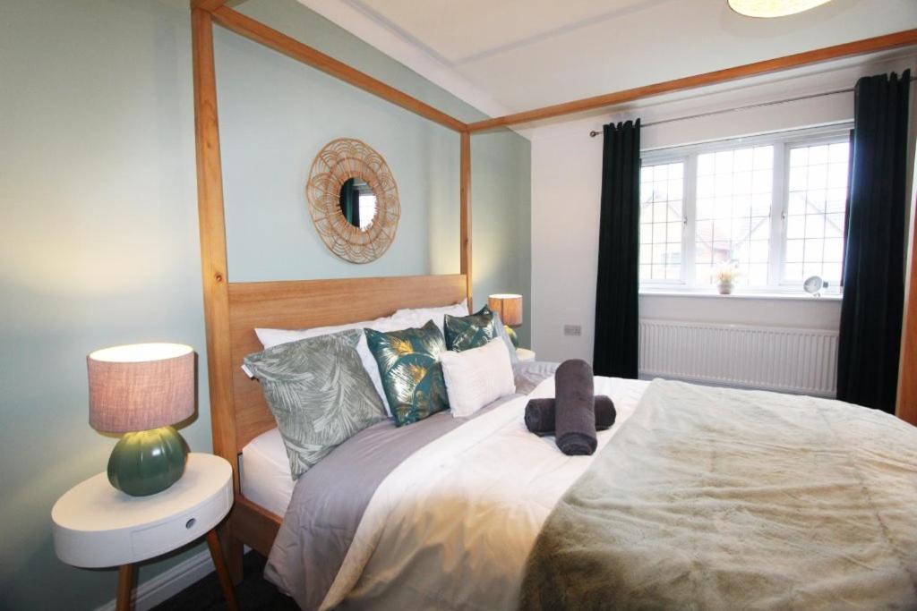 a bedroom with a large bed and a window at 4 Bedroom House Near Manchester Airport, Wythenshawe Hospital and Trafford Centre in Wythenshawe
