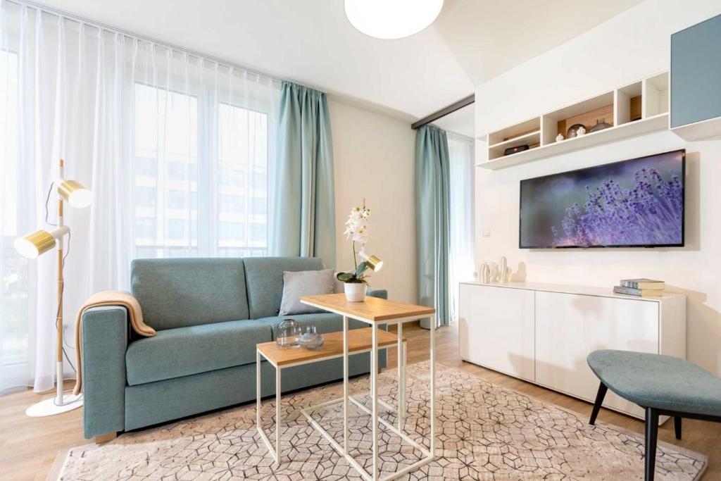 a living room with a couch and a tv at NINO-Boardinghouse 20 in Nordhorn