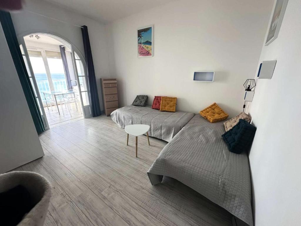 un salon avec deux lits et un canapé dans l'établissement Résidence Oustalet - Studio avec magnifique vue panoramique sur la mer à St Cyr Sur mer MAE-1611, aux Lecques
