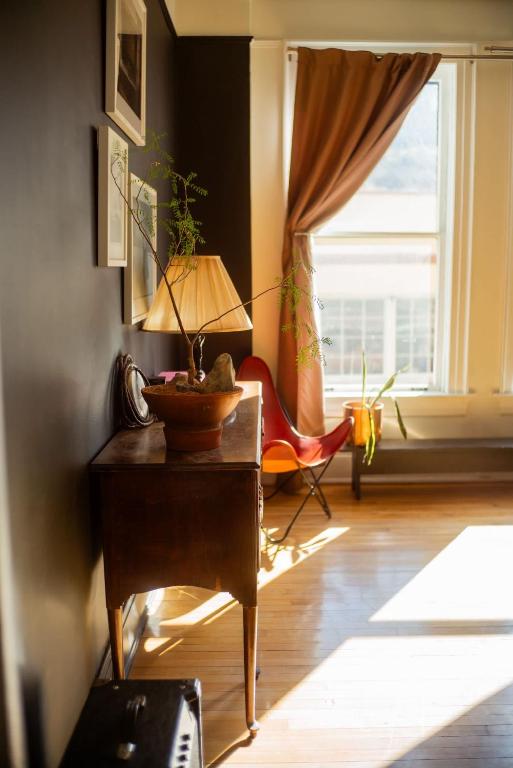 a living room with a table with a lamp on it at Object Hotel 2BR Room 2B in Bisbee