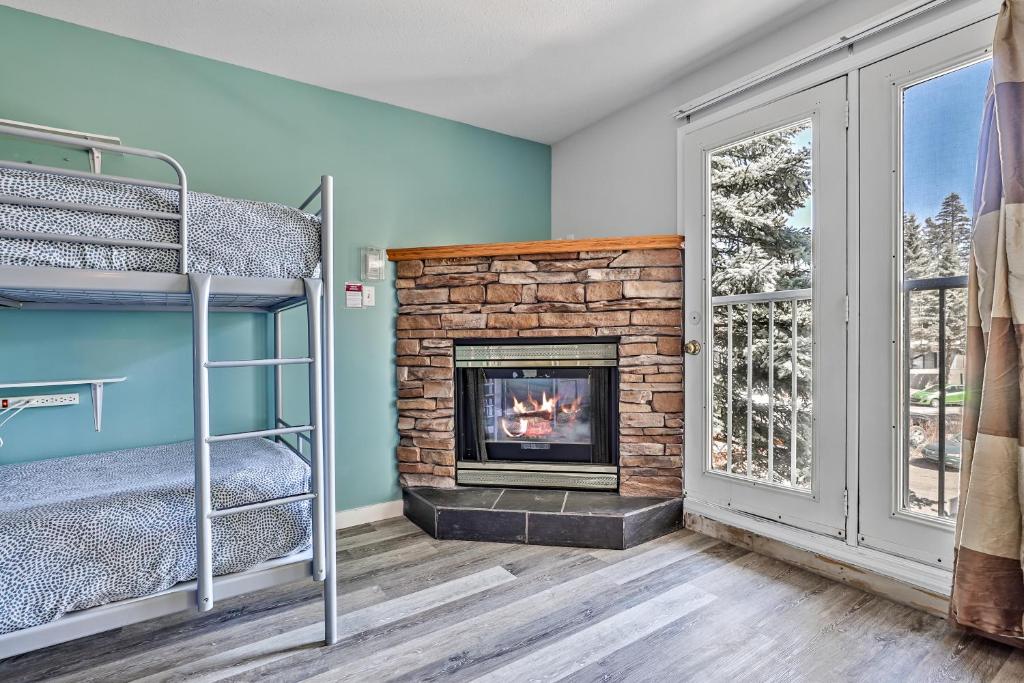 a room with two bunk beds and a fireplace at Samesun Banff Hostel in Banff
