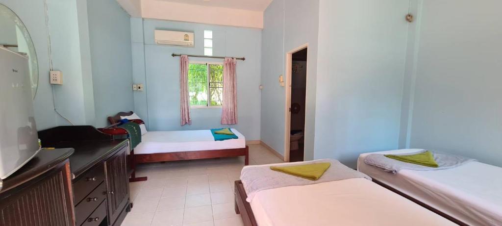 Postel nebo postele na pokoji v ubytování Sarin Guesthouse สาริน