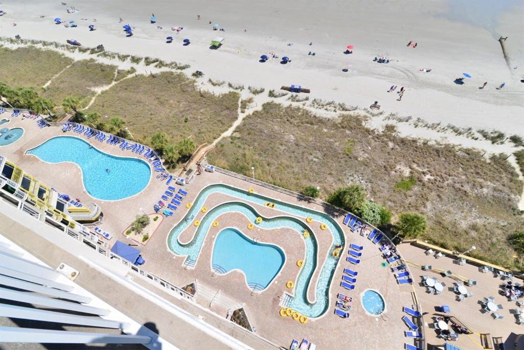 an aerial view of a water park next to the beach at Oceanfront TOP LOCATION MODERN RESORT Lazy River Huge Pool Oasis in Myrtle Beach