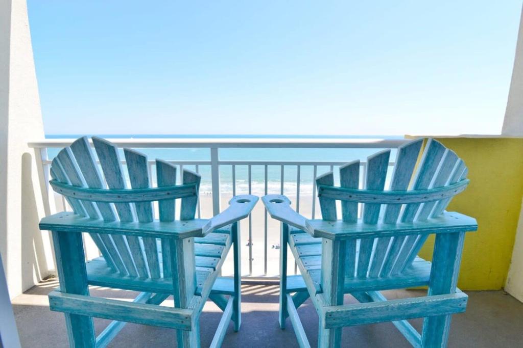 two blue chairs sitting next to each other on a balcony at Oceanfront TOP LOCATION MODERN RESORT Lazy River Huge Pool Oasis in Myrtle Beach