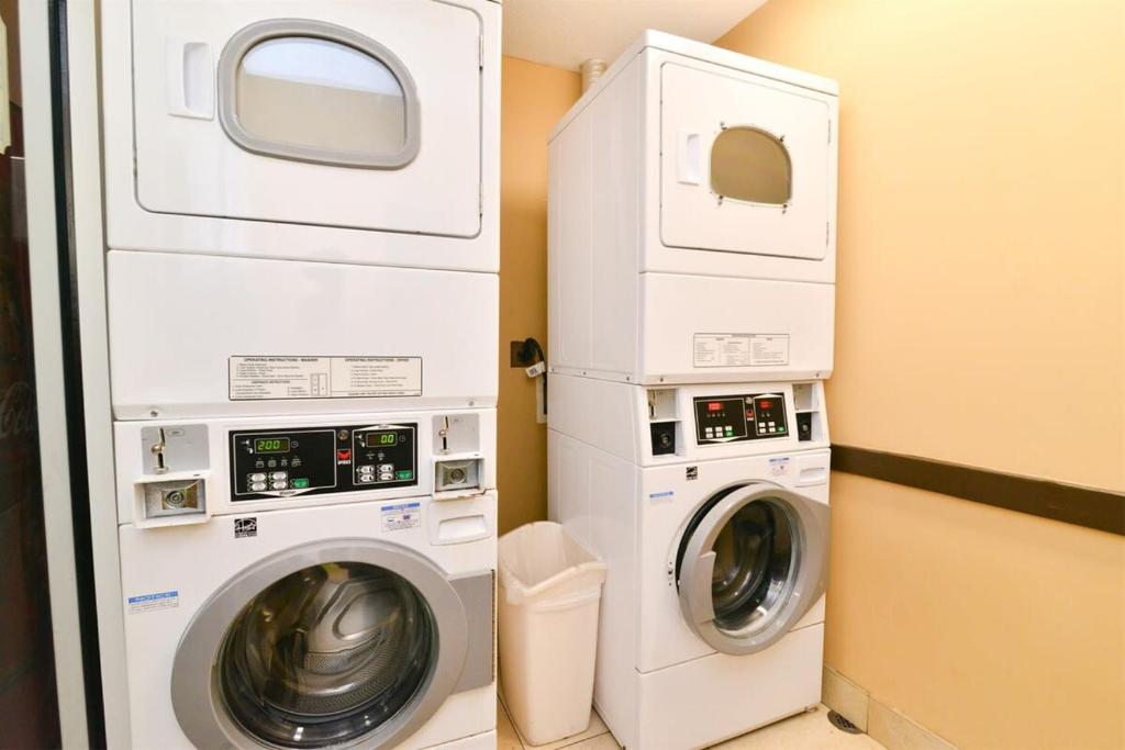 a laundry room with a washer and dryer at Oceanfront TOP LOCATION MODERN RESORT Lazy River Huge Pool Oasis in Myrtle Beach