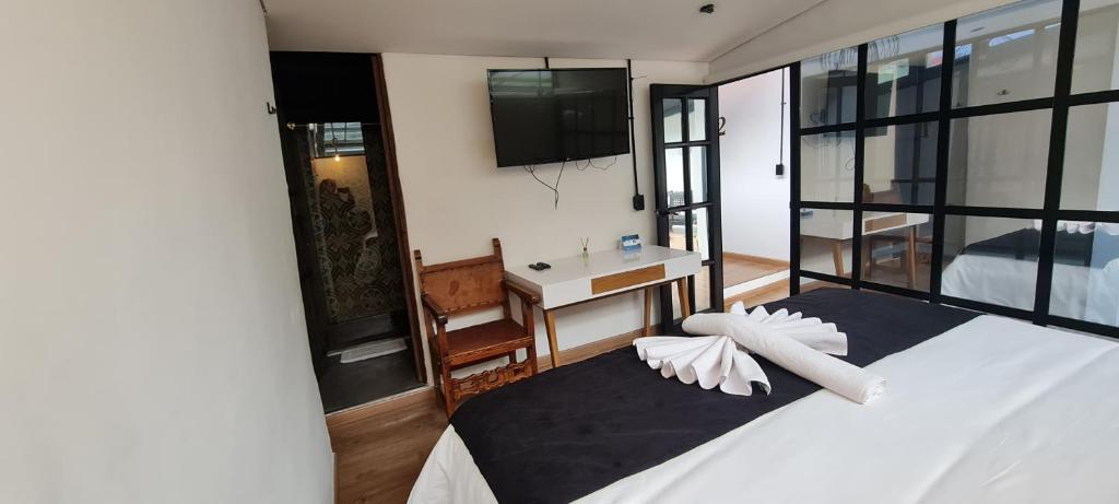 Postel nebo postele na pokoji v ubytování Hotel Quinta Bolivar