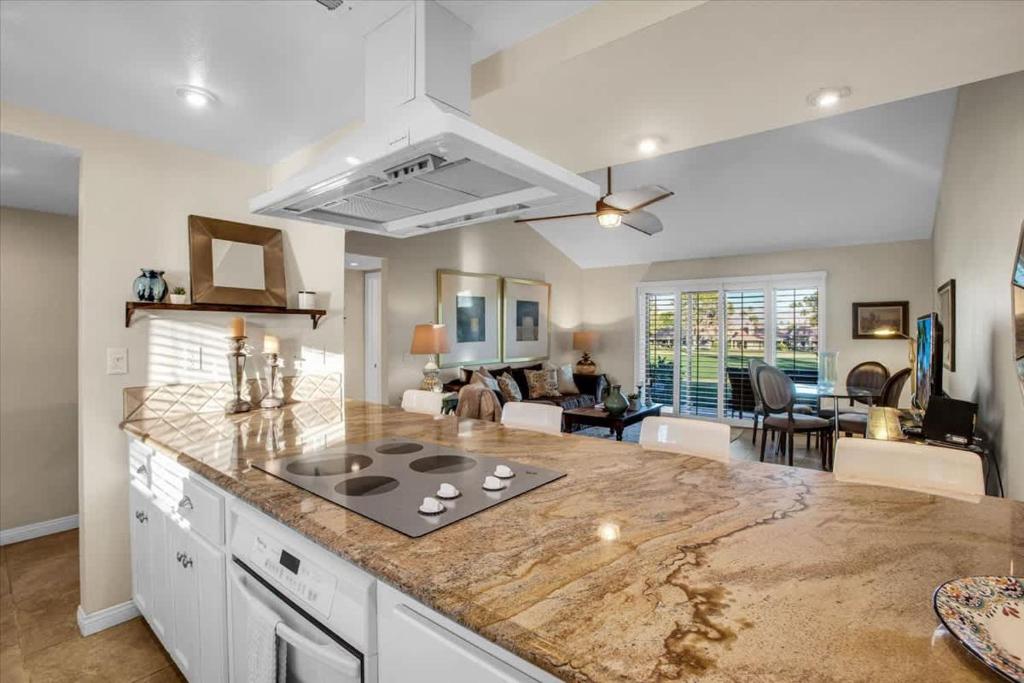 a kitchen with a counter top and a living room at PD Resorter 2BR with Golf course views in Palm Desert