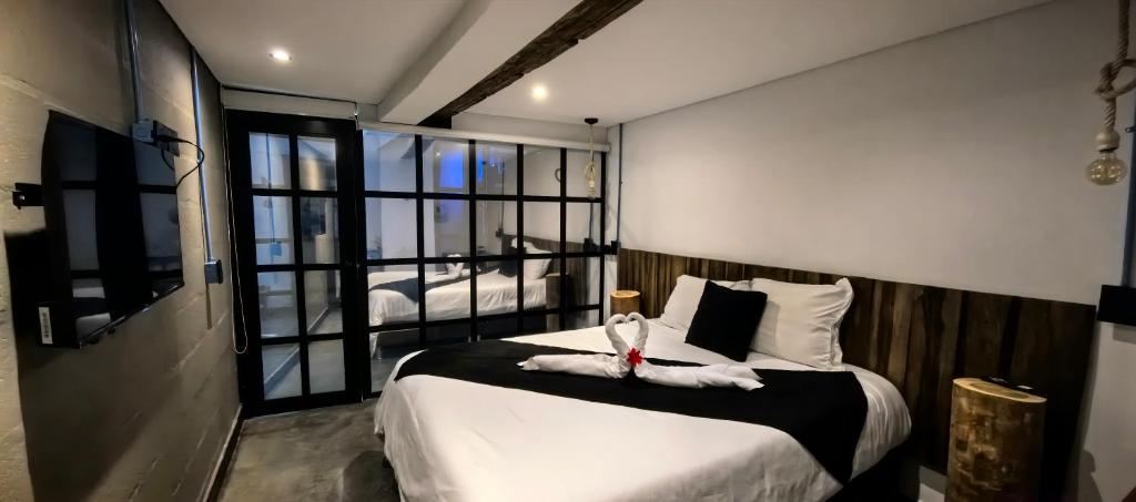 Postel nebo postele na pokoji v ubytování Hotel Quinta Bolivar