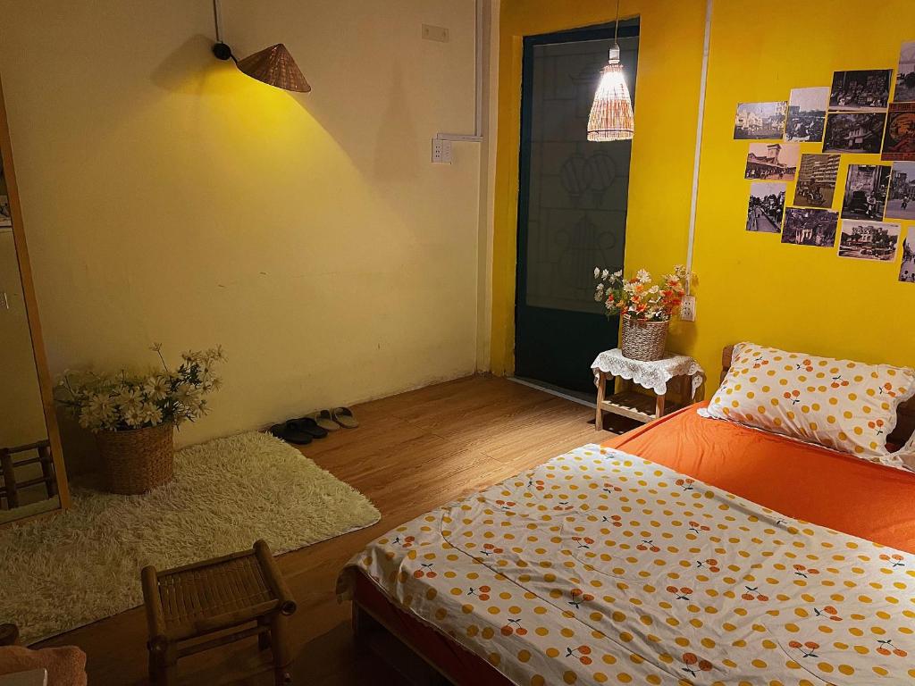 a bedroom with a bed and a chair and a door at Chang ơi homestay Sai Gon in Ho Chi Minh City