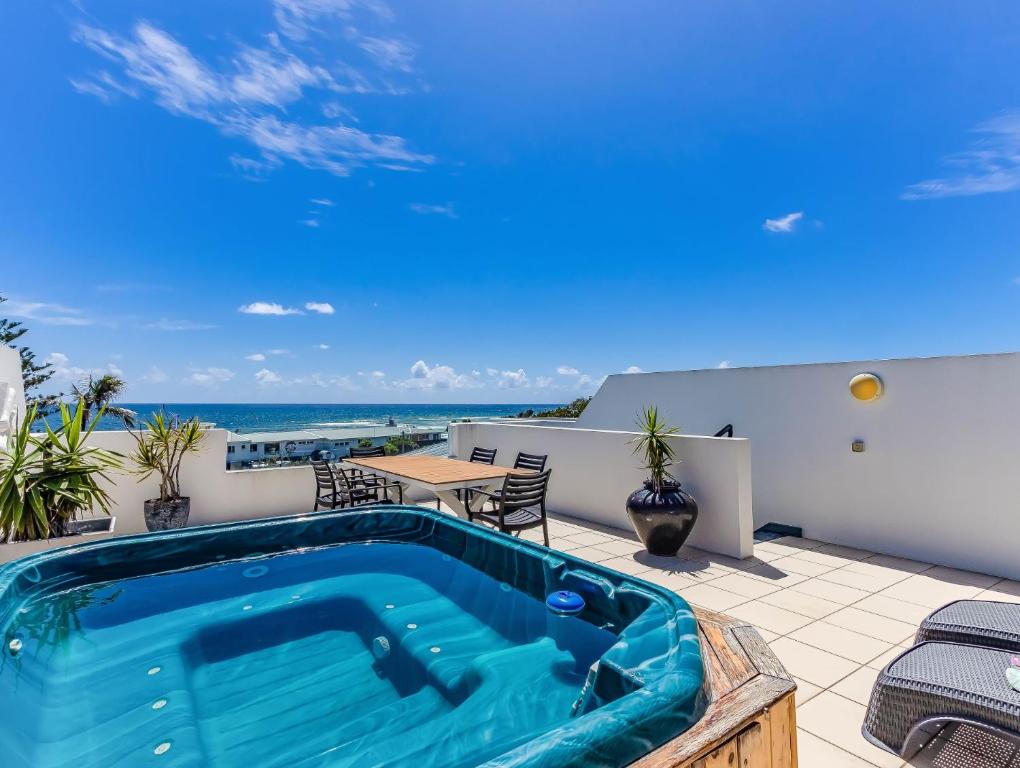 a swimming pool on the roof of a house at Luxury Oceanfront Haven with a Private Rooftop Spa in Kingscliff