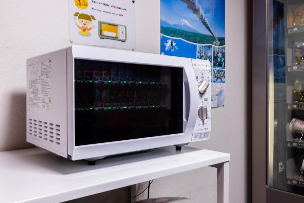 a microwave oven sitting on top of a white table at Select Inn Fujisan Gotemba in Gotemba