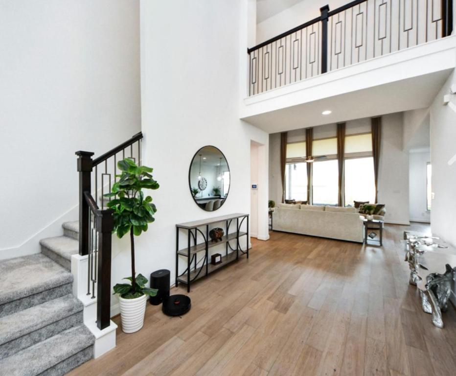 a large living room with stairs and a mirror at Prívate Room In Cypress in Hot Wells