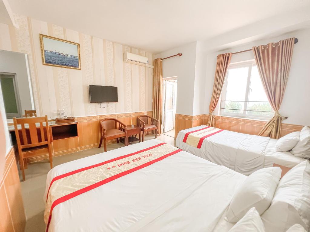 Postel nebo postele na pokoji v ubytování Ngọc Hân Hotel By The Moment