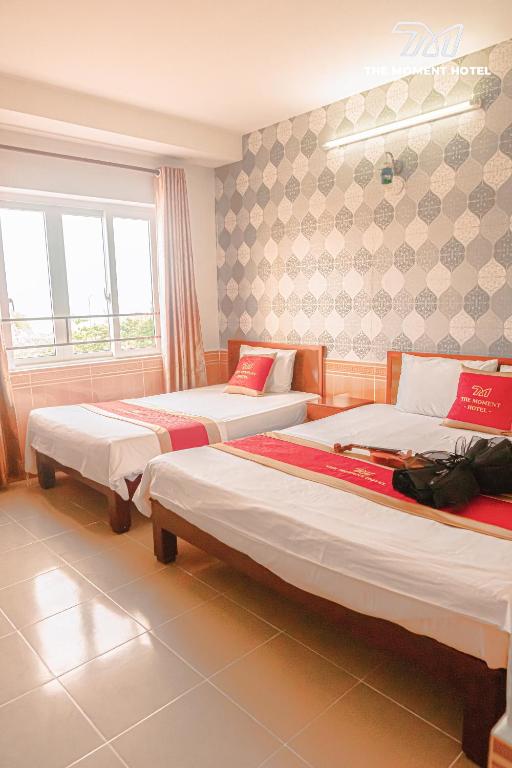 Postel nebo postele na pokoji v ubytování Ngọc Hân Hotel By The Moment