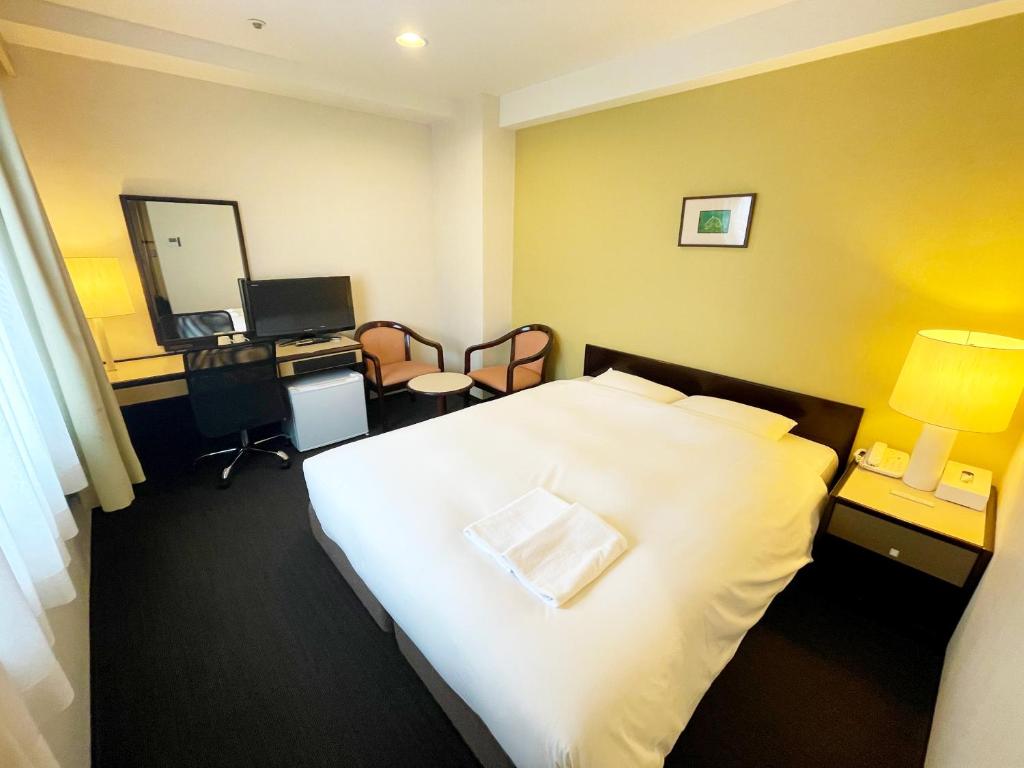 Postel nebo postele na pokoji v ubytování Smile Hotel Yonago