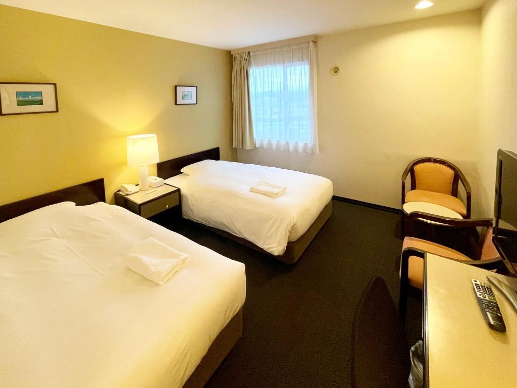 Postel nebo postele na pokoji v ubytování Smile Hotel Yonago