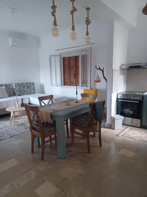 a kitchen with a table and chairs and a couch at Asprocyclia House in Kalymnos