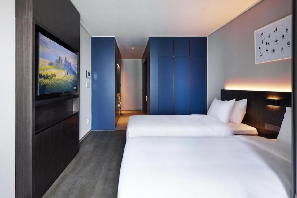 Postel nebo postele na pokoji v ubytování Homes Stay Myeongdong