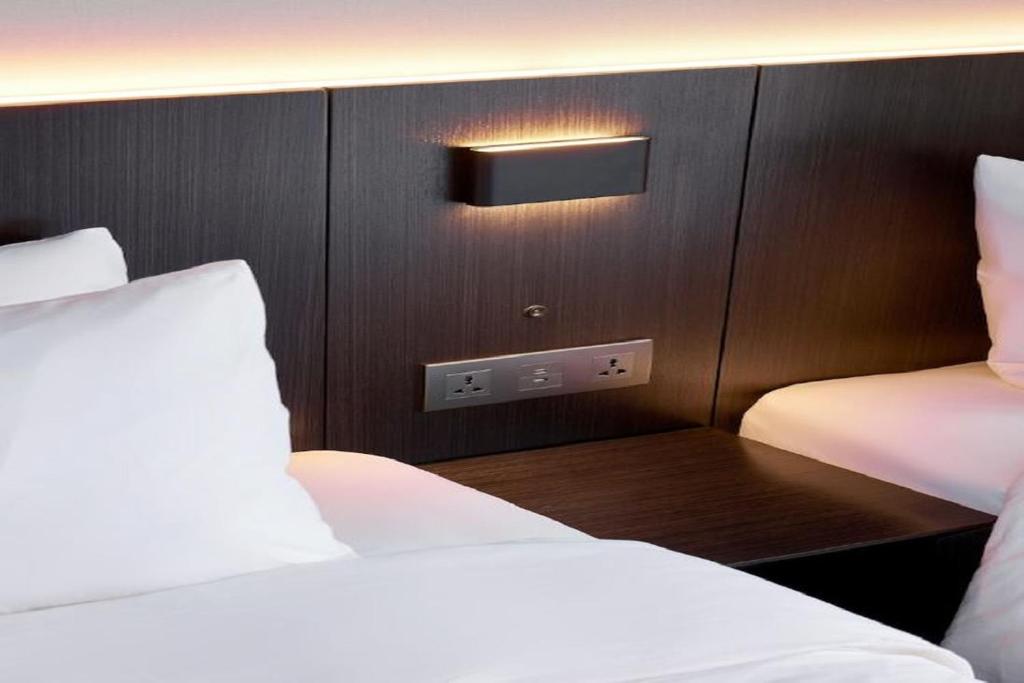 Postel nebo postele na pokoji v ubytování Homes Stay Myeongdong
