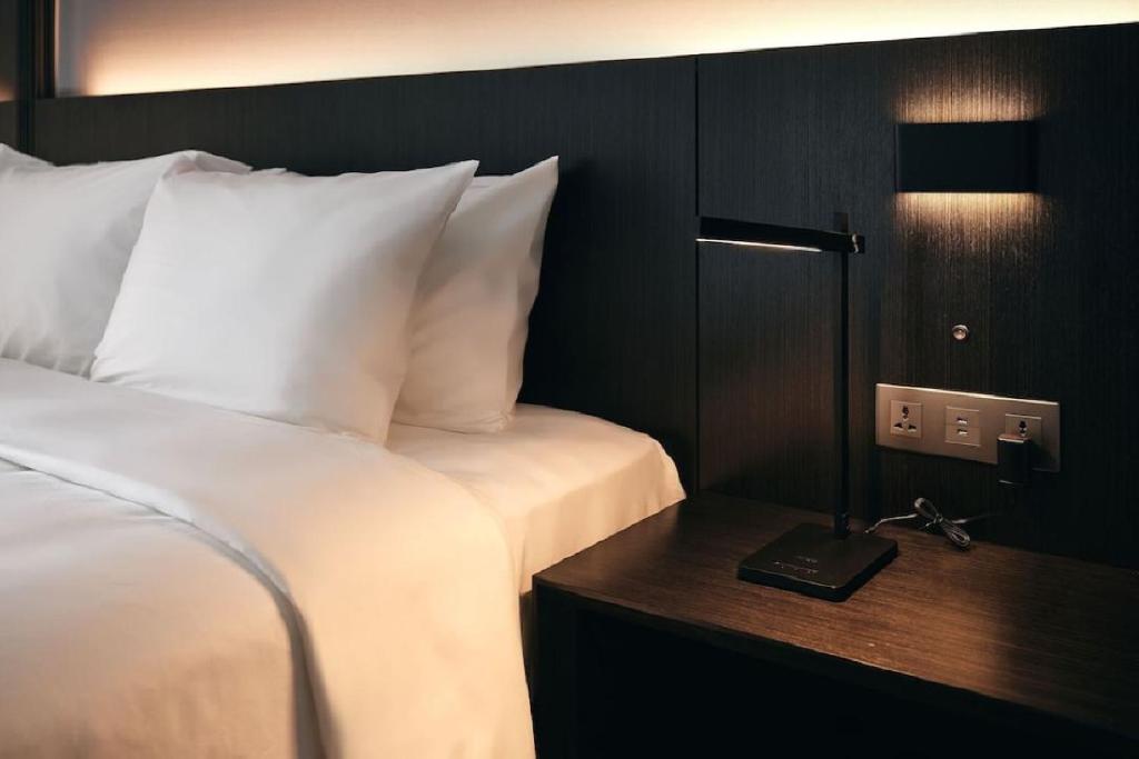 Postel nebo postele na pokoji v ubytování Homes Stay Myeongdong