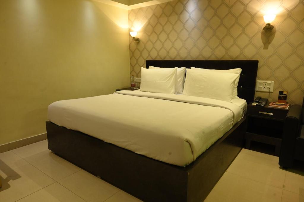 Postel nebo postele na pokoji v ubytování The Citi Residenci Hotel, Bidhannagar