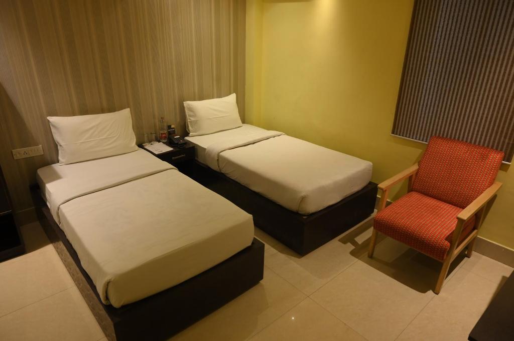Postel nebo postele na pokoji v ubytování The Citi Residenci Hotel, Bidhannagar