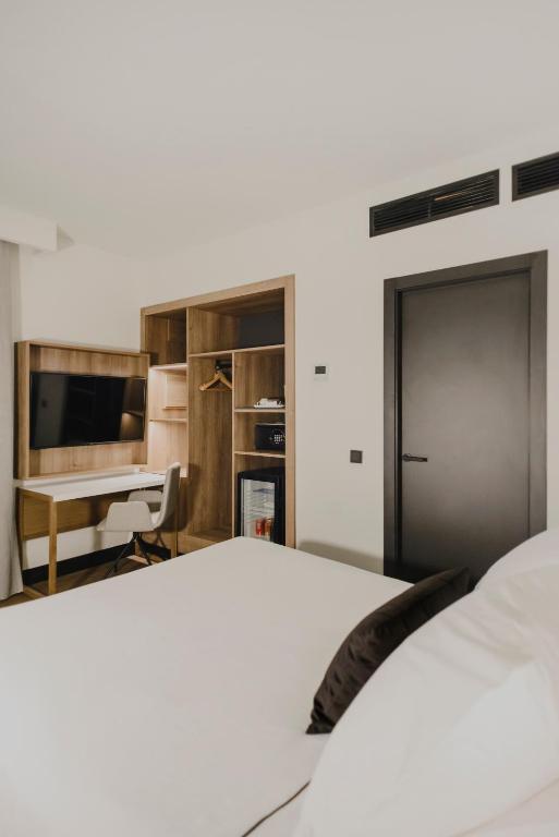 Postel nebo postele na pokoji v ubytování Hotel Dimar