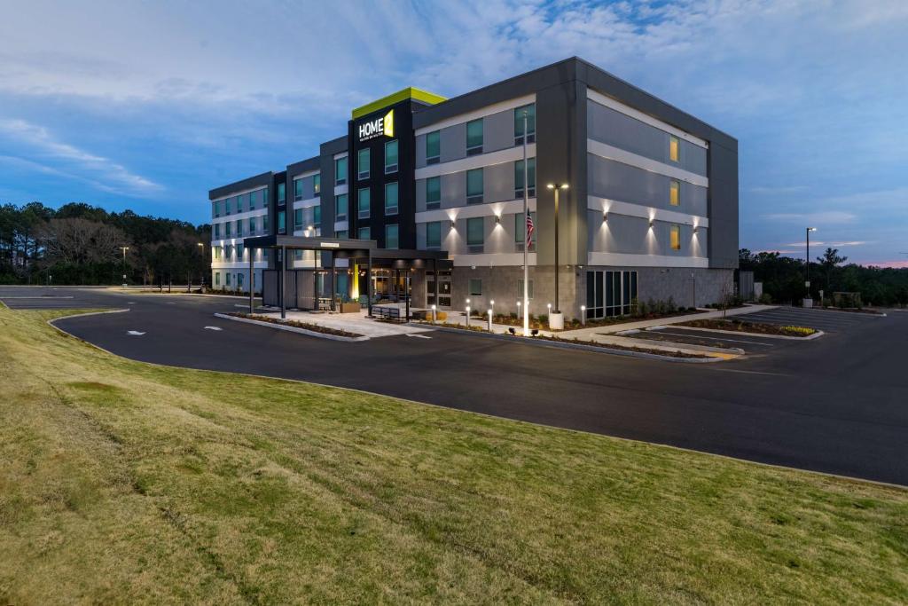 a rendering of a building with a parking lot at Home2 Suites By Hilton Troy, Al in Troy