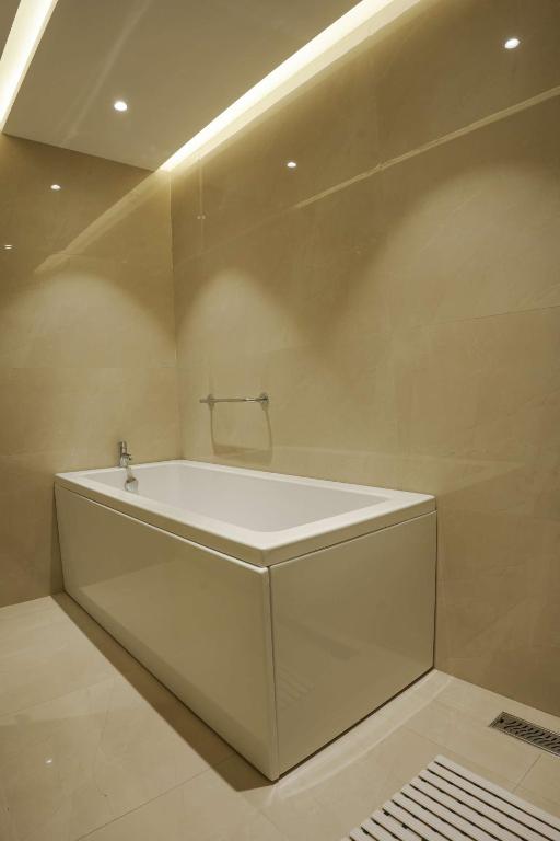 a white bath tub sitting in a bathroom at Best Western AH1 Amritsar in Amritsar